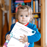 A child holding their My Amazing Year Children's Learning Journal for EYLF