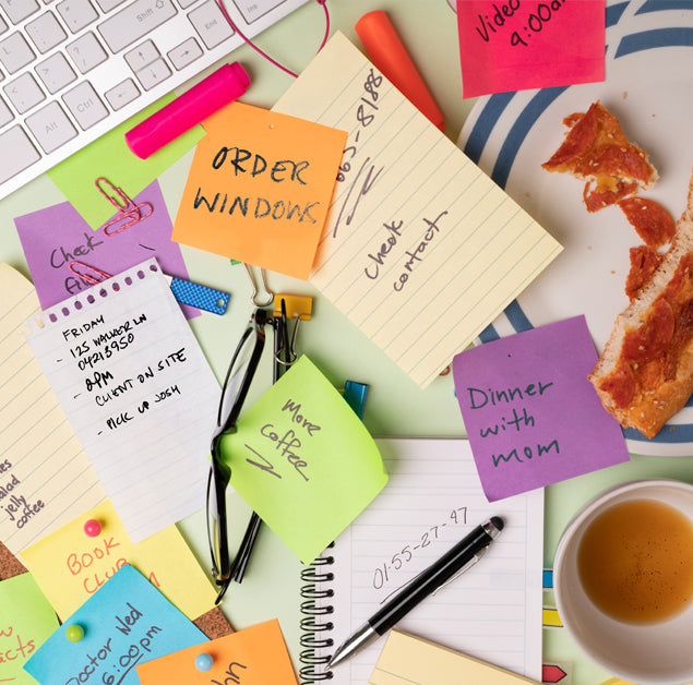 Messy desk full of postit notes