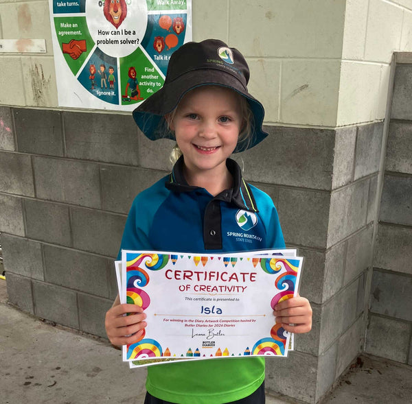young girl holding up her certificate