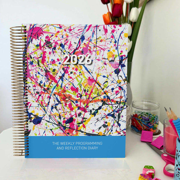 EYLF Weekly Programming and Reflection Diary with Rainbow Falls Child Artwork Cover sitting on Educator's desk