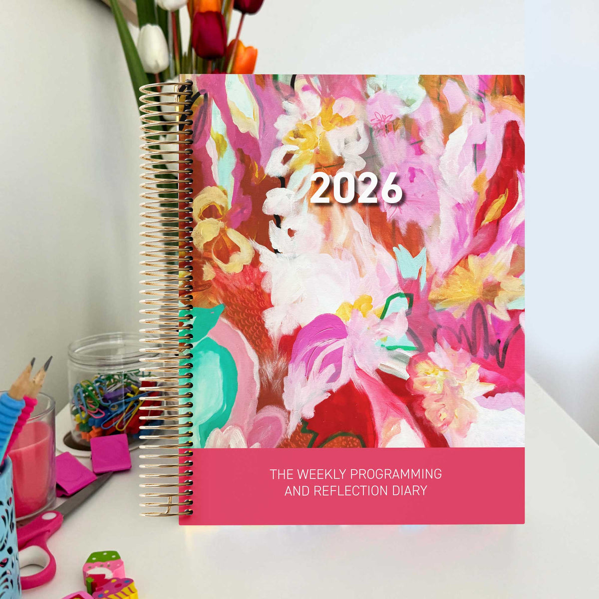 EYLF Weekly Programming and Reflection Child Educator Diary with Dancing with Pink Artwork Cover sitting on an Educator's desk