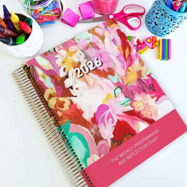 EYLF Weekly Programming and Reflection Diary with Dancing with Pink Artwork Cover sitting on a programming desk in ECEC