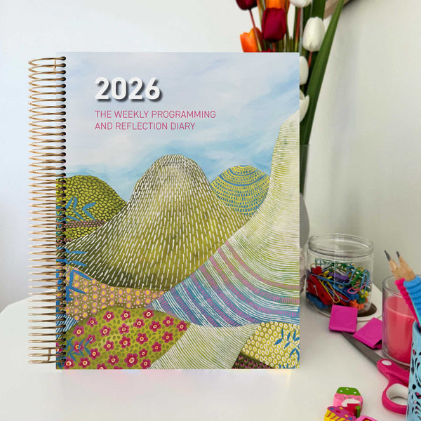 EYLF Weekly Programming and Reflection Diary with Glasshouse Mountains Artwork Cover sitting on Educator's desk