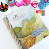 EYLF Weekly Programming and Reflection Diary with Glasshouse Mountains Artwork Cover sitting on an Educator's planning desk