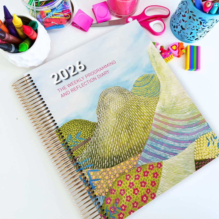 EYLF Weekly Programming and Reflection Diary with Glasshouse Mountains Artwork Cover sitting on an Educator's planning desk