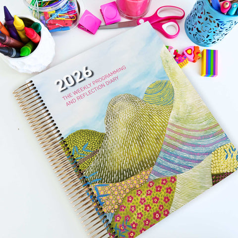 EYLF Weekly Programming and Reflection Diary with Glasshouse Mountains Artwork Cover sitting on an Educator's planning desk