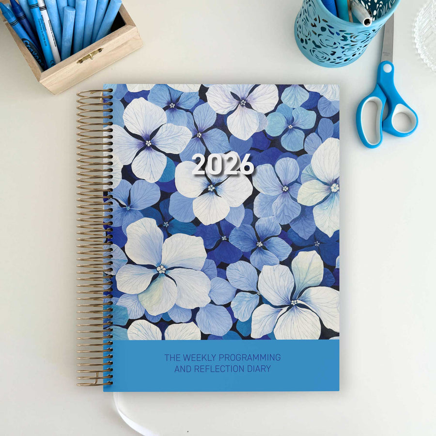 EYLF Weekly Programming and Reflection Child Educator Diary with Blue Heaven Artwork Cover sitting on an Educator's desk