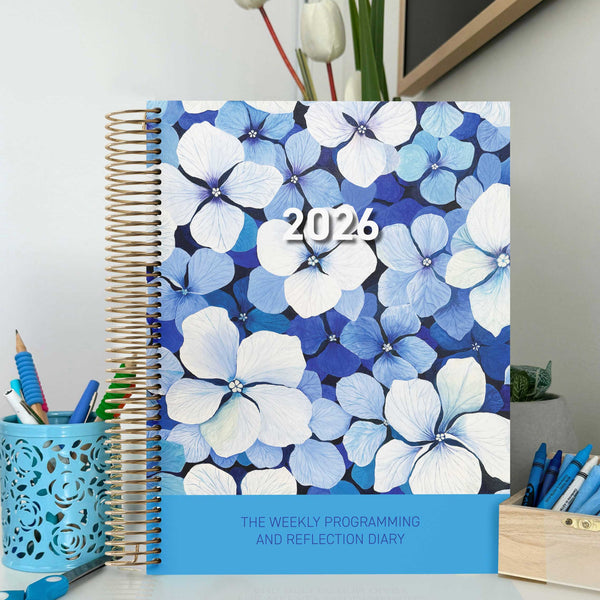 EYLF Weekly Programming and Reflection Diary with Blue Heaven Artwork Cover sitting on a educator's programming desk