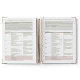 Open spiral-bound book with pages showing text on a white background