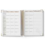 Open planner showing weekly and daily schedules on white background