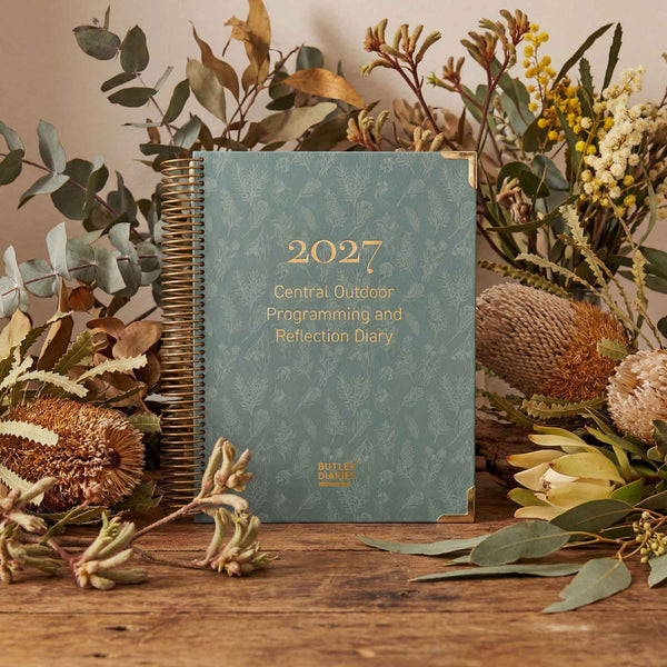 2027 diary with floral and plant decorations on a wooden surface