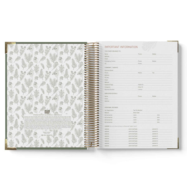 Open spiral-bound book with floral pattern on one page and text on the other, on a white background.