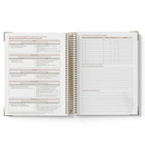 Open spiral-bound notebook with printed pages on a white background