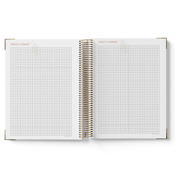Open spiral-bound planner with grid pages on a white background