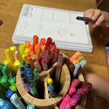 A child completing the Children's Voices Diary using colourful crayons