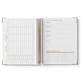 Open spiral-bound ECEC Cook Diary with quality improvement goals section on a white background