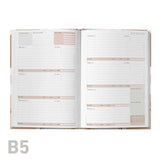 Open educator planner with B5 size label on a white background