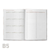 Open meeting log book with detailed schedules on a white background