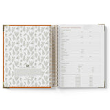 Open spiral-bound 2027 Educational Leader Diary with floral pattern on left page and text on right page.