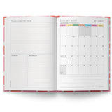 Open planner showing a monthly calendar and notes section on a white background