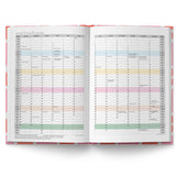 Open planner with colorful monthly tabs on a white background