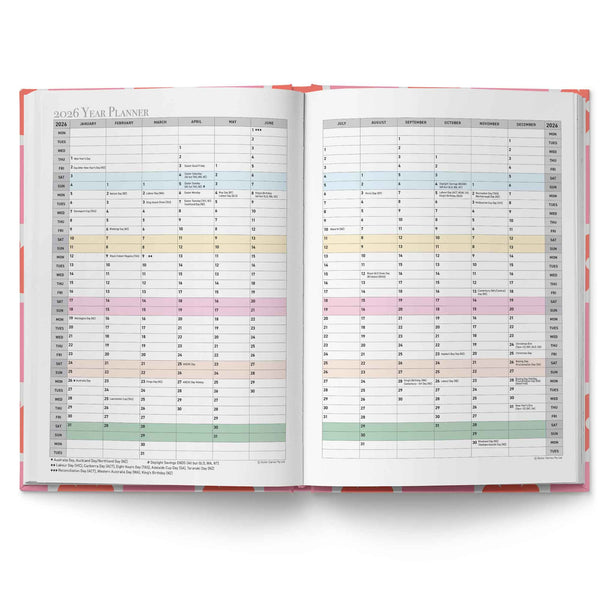 Open planner with colorful monthly tabs on a white background