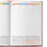 Open planner showing a weekly layout with colorful headers for each day of the week.