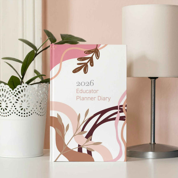 2026 Educator Planner Diary on a table with a lamp and plant in the background