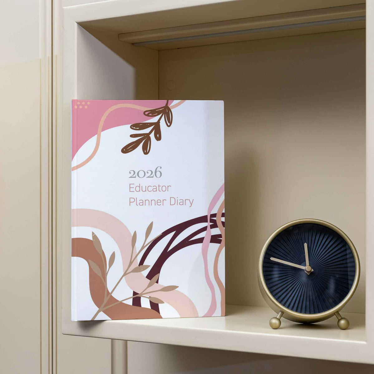 2026 Educator Planner Diary on a shelf with a clock