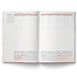Open planner showing monthly calendar pages for December and January on a white background