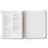Open notebook with a list on one page and notes on the other, on a white background