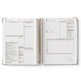 Open daily planner with January 2023 dates on a white background