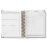 Open planner with white pages on a white background