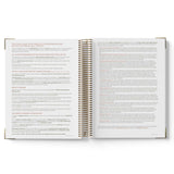 Open spiral-bound book with text on a white background