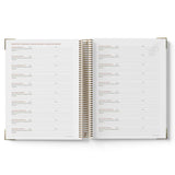 Open spiral-bound 2027 Family Day Care Checklist Diary with white pages on a white background