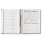 Open spiral-bound 2027 Family Day Care Checklist Diary with grid and text pages on a white background
