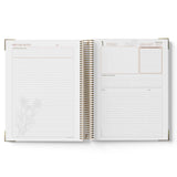 Open spiral-bound 2027 Nominated Supervisor Diary with meeting notes and calendar pages on a white background