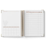 Open spiral-bound 2027 Nominated Supervisor Diary with grid and checklist pages on a white background