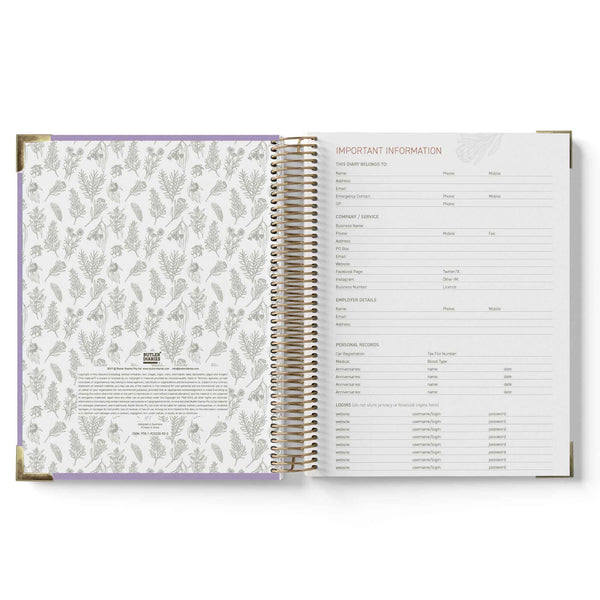Open spiral-bound planner with floral pattern on one page and text on the other, on a white background.