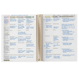 Open spiral-bound planner with text and notes on a white background