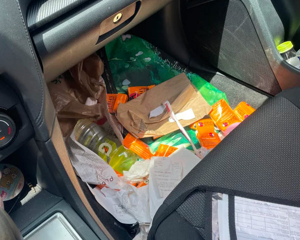Messy Tradie car with receipts and notes