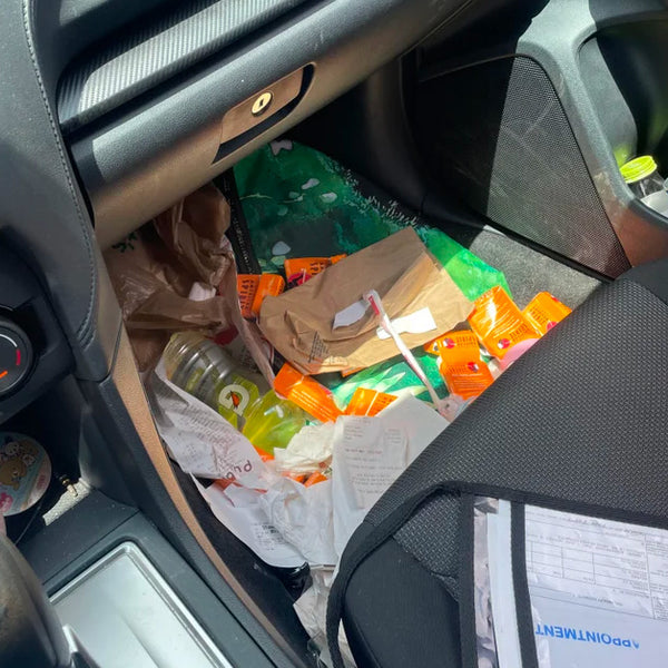 Messy Tradie car with receipts and notes