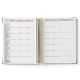 Open QLD Kindy Programming Diary showing weekly and daily schedules on white background