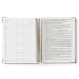 Open spiral-bound QLD Kindy Programming Diary showing pages with text on a white background