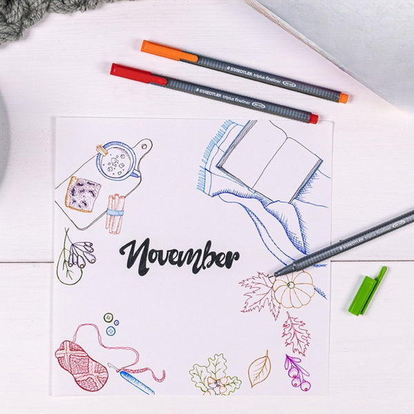 Colorful illustration of November with stationery items on a white surface.