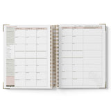 Open teacher planner showing weekly and monthly scheduling on a white background