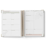 Open teacher planner showing weekly and monthly layout on white background
