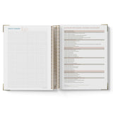 Open teacher planner with grid and text pages on a white background