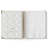 Open 2027 ECEC Programming Diary with floral pattern on one page and text on the other, on a white background