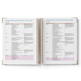 Open spiral-bound 2027 ECEC Programming Diary with pages showing developmental milestone lists on a white background